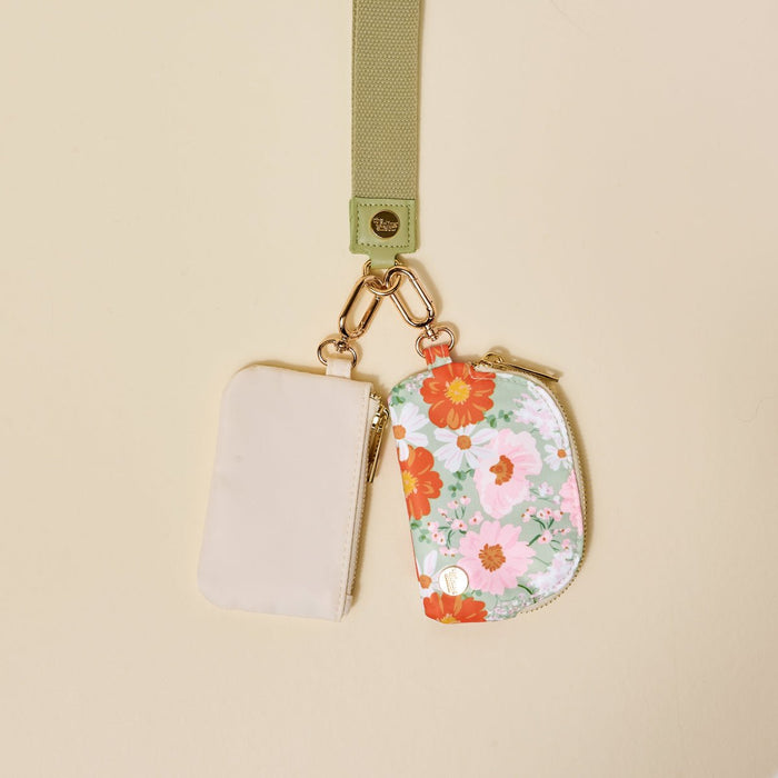 The-darling-effect’s Bouquet Beauty Sage Dynamic Duo Pouch Wristlet features a luxe lanyard with a gold clasp, holding two chic zippered pouches—one beige, one floral—for stylish hands-free carrying.