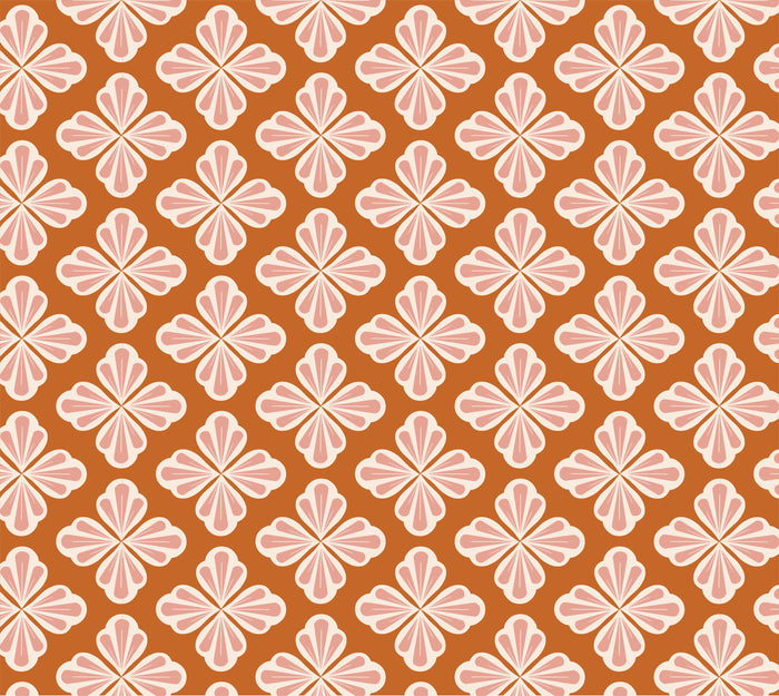 Repeating pattern of cream and pink floral shapes with four petals, outlined in brown, arranged diagonally on a warm brown-orange background.
