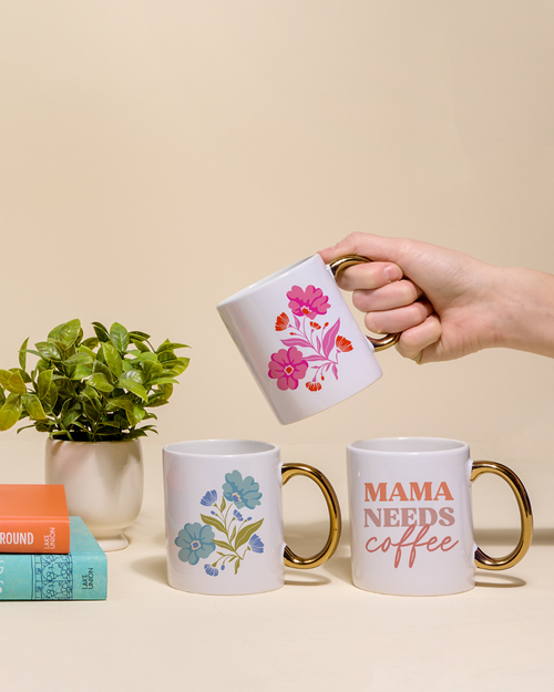 The Darling Effect's Mahjong Tiles 11 oz Cozy Cute Ceramic Mug features a golden handle and vibrant playing card-style fruit, veggie, bamboo, and bird designs—perfect for coffee or tea on a plain light background.
