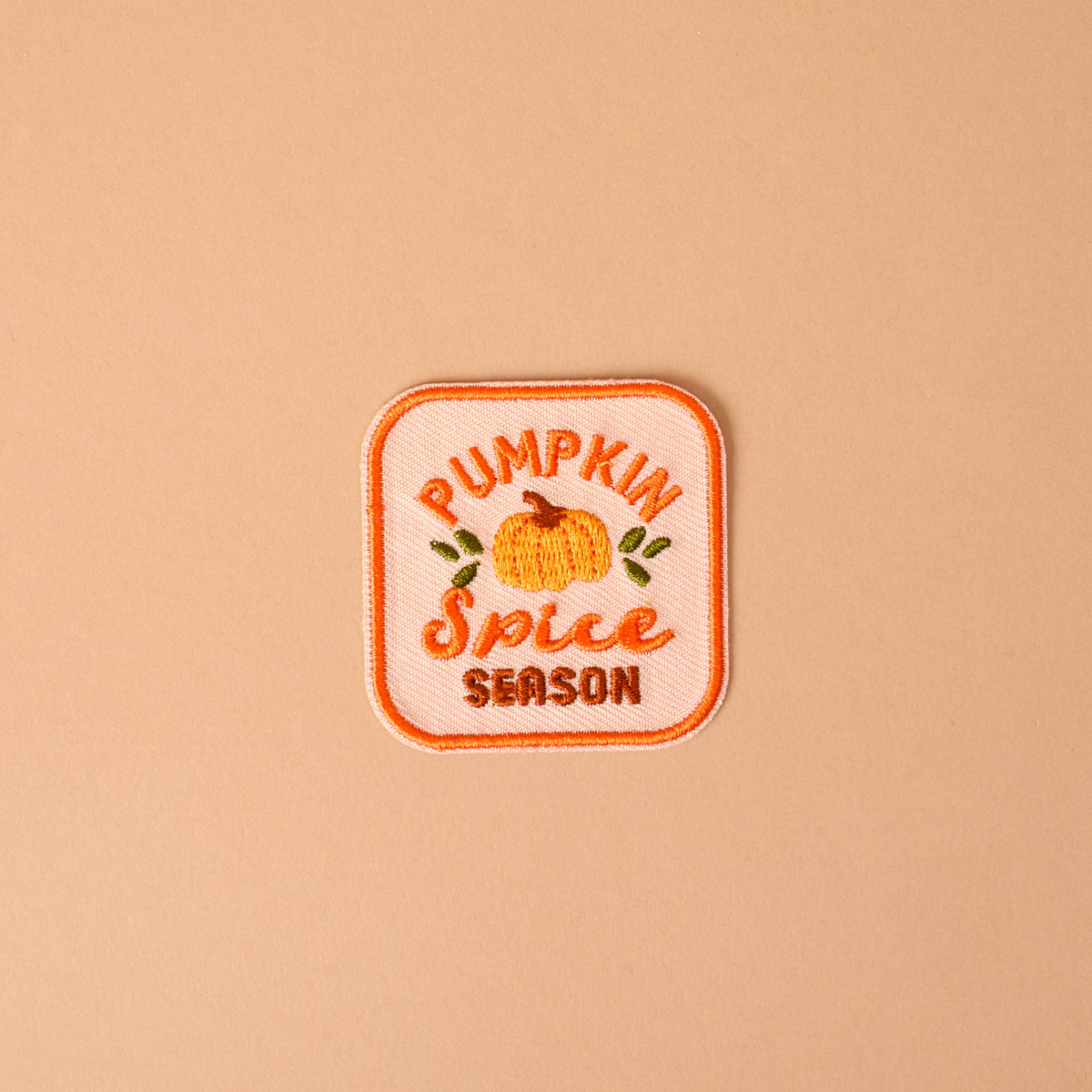 Bring a cozy autumn vibe to your favorite jacket or bag with The Darling Effect’s On Patch-Pumpkin Spice Season Mix & Match Iron! This embroidered patch features a charming pumpkin illustration along with the words “Pumpkin Spice Season” in vibrant orange and yellow on a light peach background—perfect for customizing your look and adding seasonal flair with colorful, iron-on designs.