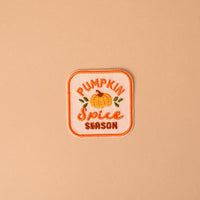 Bring a cozy autumn vibe to your favorite jacket or bag with The Darling Effect’s On Patch-Pumpkin Spice Season Mix & Match Iron! This embroidered patch features a charming pumpkin illustration along with the words “Pumpkin Spice Season” in vibrant orange and yellow on a light peach background—perfect for customizing your look and adding seasonal flair with colorful, iron-on designs.