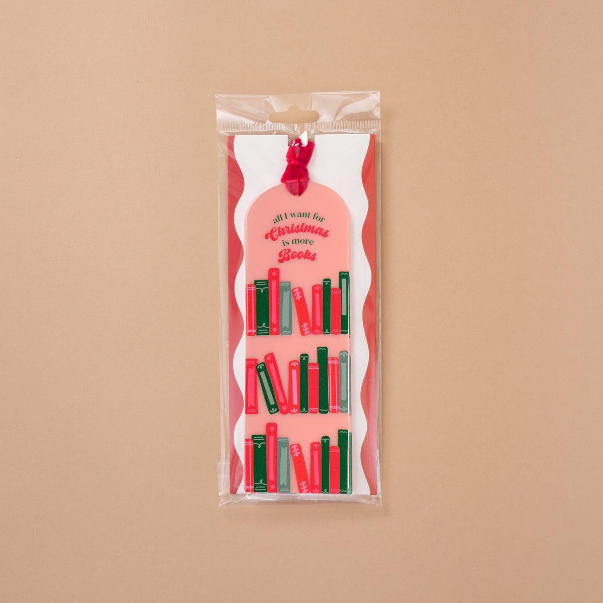 The All I Want for Christmas is More Books Acrylic Bookmark is a clear acrylic bookmark with a velvet ribbon and printed illustrations of red and green books, featuring the text all i want for Christmas is more Books.