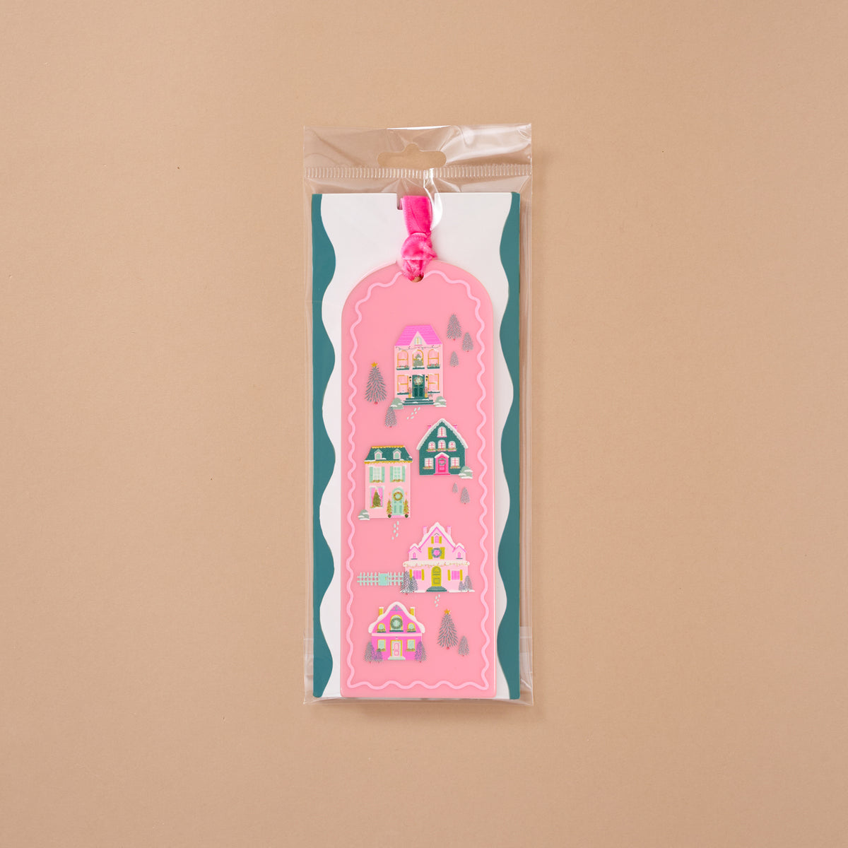 Pink Pine Village Acrylic Bookmark featuring a vertical pattern of four whimsical houses, finished with a velvet ribbon loop.
