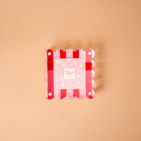 Peppermint Stripes Little Moments Acrylic Picture Frame featuring a square shape with a scalloped edge, red and white stripes, and a pink snowflake-patterned insert.