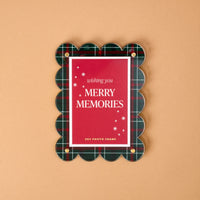 Evergreen Plaid Mini Acrylic Picture Frame Magnet holding a red card that says wishing you MERRY MEMORIES with white snowflake icons.