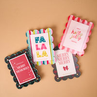 Four A Merry Moment Mini Acrylic Picture Frame Magnets with scalloped edges, each displaying holiday inserts that read FA LA LA, HAVE A holly jolly CHRISTMAS, MERRY MERRY MERRY, and wishing you MERRY MEMORIES.