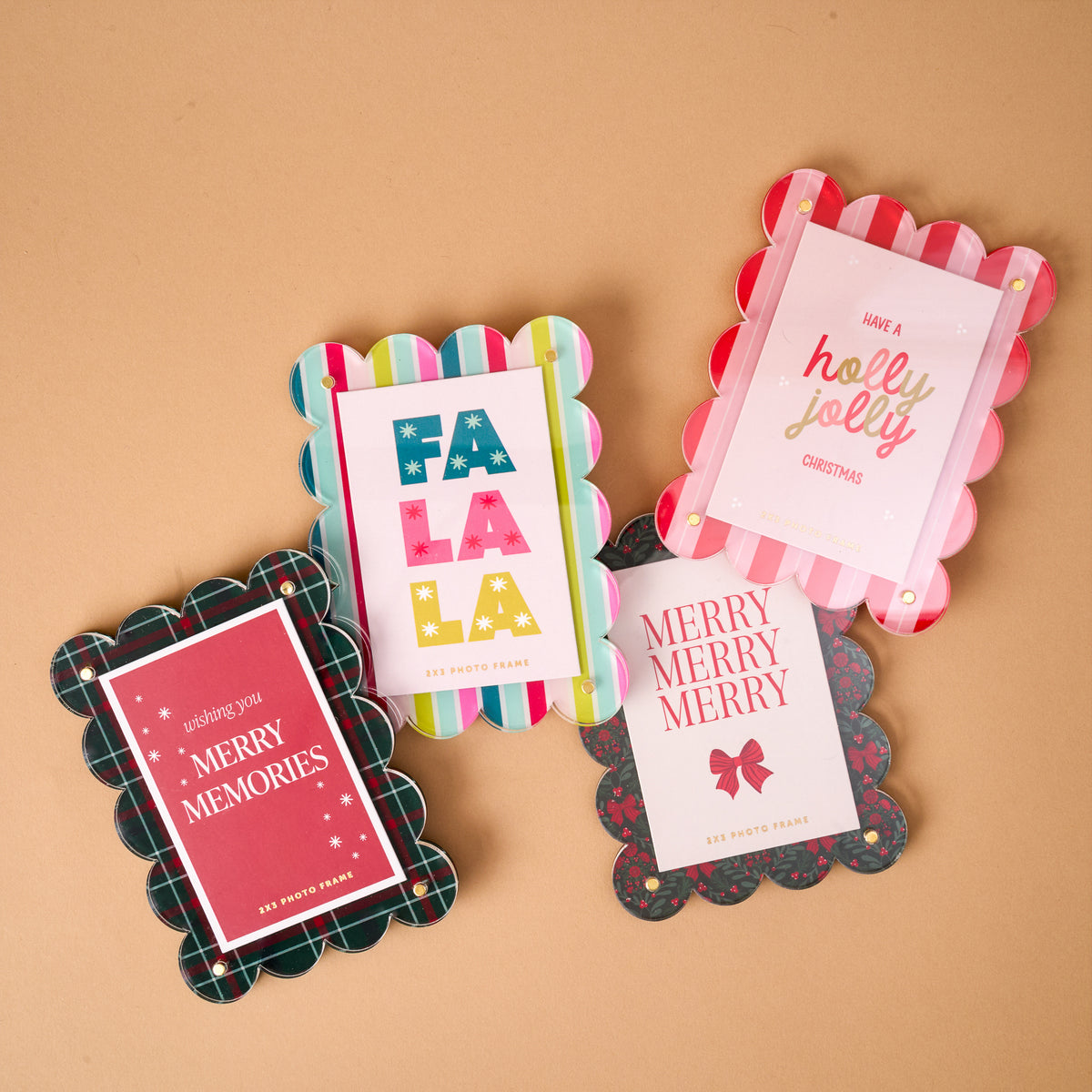 Four Peppermint Stripes Mini Acrylic Picture Frame magnets with holiday inserts that read Fa La La, Have a Holly Jolly Christmas, Wishing You Merry Memories, and Merry Merry Merry.
