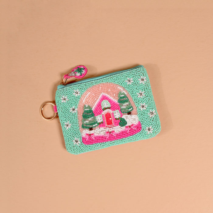 Snowy Dreams Handcrafted Beaded Pouch, a mint green zippered pouch featuring a snow globe design with a pink house and pine trees.