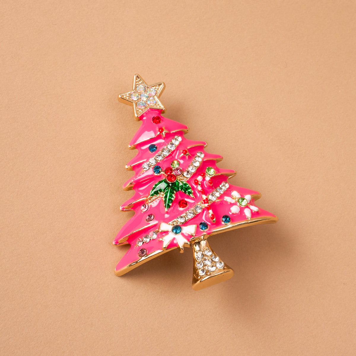 Whimsical Tree Timeless Brooch featuring a pink enameled Christmas tree decorated with colorful crystals, green holly leaves, and a star topper; a vintage-inspired keepsake accessory.