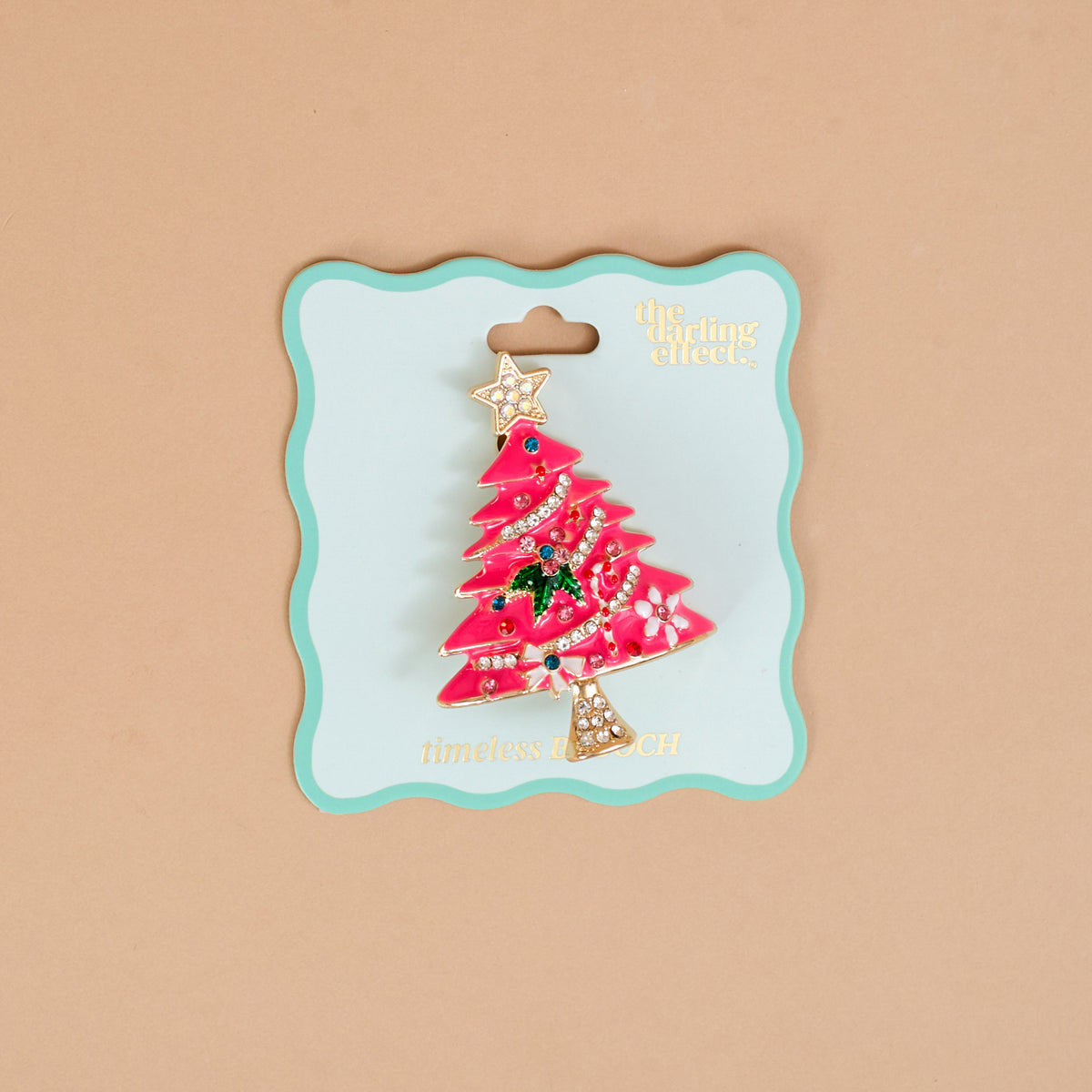 Whimsical Tree Timeless Brooch featuring a pink enamel Christmas tree decorated with colorful crystals and a star topper, presented as a vintage-inspired keepsake accessory on a decorative display card.