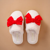 Betty Bow Red On Cloud Nine Slippers in white faux fur, each featuring a large red bow on the top.