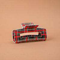 Evergreen Plaid Claw Clip: a rectangular printed claw clip with a dark green, red, and white plaid pattern.