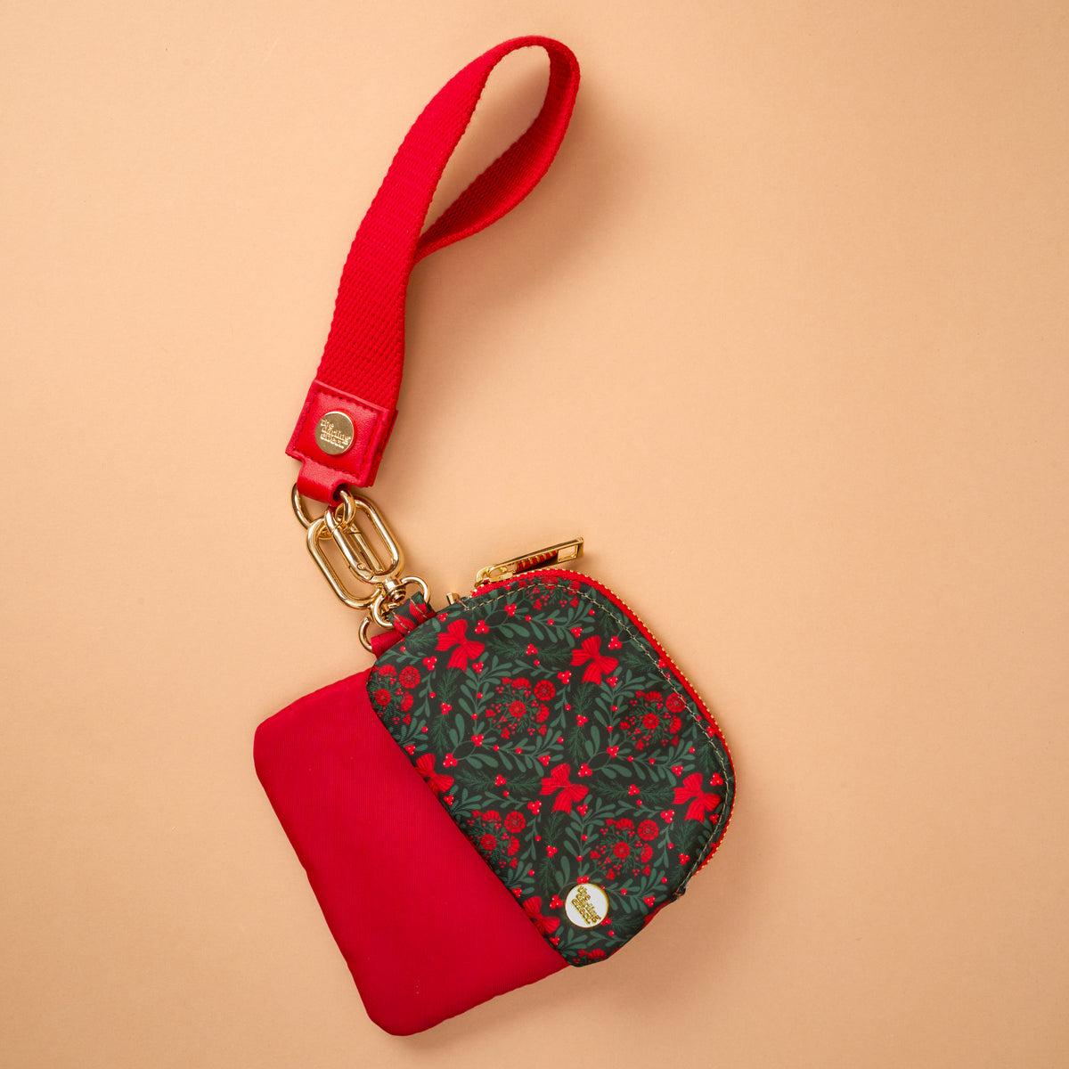 The Darling Effect A Merry Moment Dynamic Duo Pouch Wristlet in luxe red and dark green floral with a red strap and gold hardware, perfect for hands-free carry.