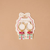 BowBelle Manor Signature Hoop Earrings, gold hoops featuring house-shaped pendants with pink rhinestone roofs and green decorative wreaths.