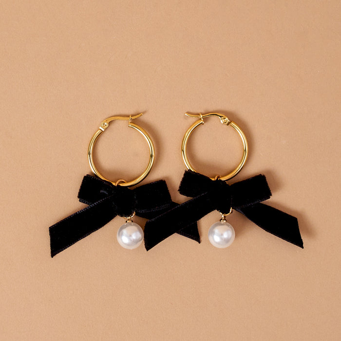 Midnight Velvet Signature Hoop Earrings featuring gold hoops, black ribbon bows, and single dangling white pearls.