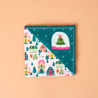 Sugarplum Lane Corner Keeper Fabric Bookmark with a diagonal divide, featuring a snowy village scene on one side and a teal background with a Christmas tree snow globe on the other.