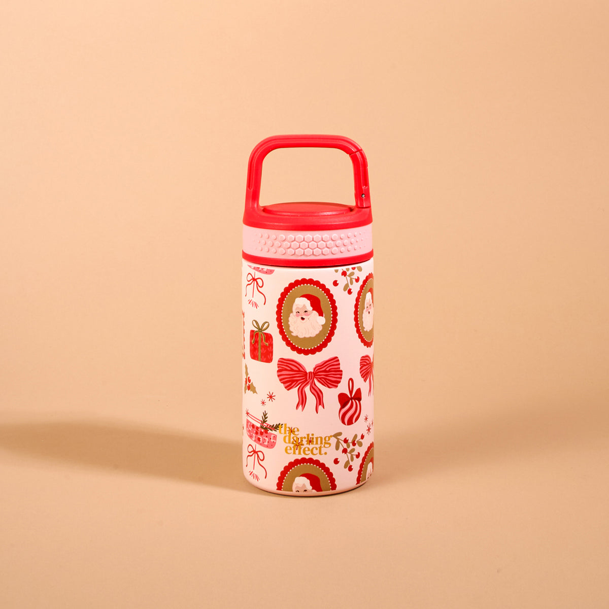 Mistletoe Magic 6 oz Lil’ Bitty Bottle, a petite insulated water bottle with a red carrying handle and a festive pattern of Santa Claus, gift boxes, and bows.