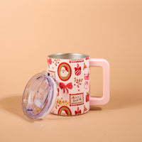 Mistletoe Magic 14 oz Insulated Mug featuring a pastel pink handle and a pattern of Christmas imagery including Santa, bows, and presents, shown with its clear lid resting beside it.