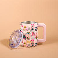 Sugarplum Lane 14 oz Insulated Mug with a handle and a clear lid, featuring a repeating pattern of colorful houses, wreaths, and pine trees.