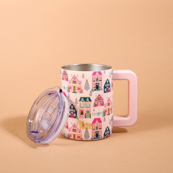 Sugarplum Lane 14 oz Insulated Mug with a handle and a clear lid, featuring a repeating pattern of colorful houses, wreaths, and pine trees.