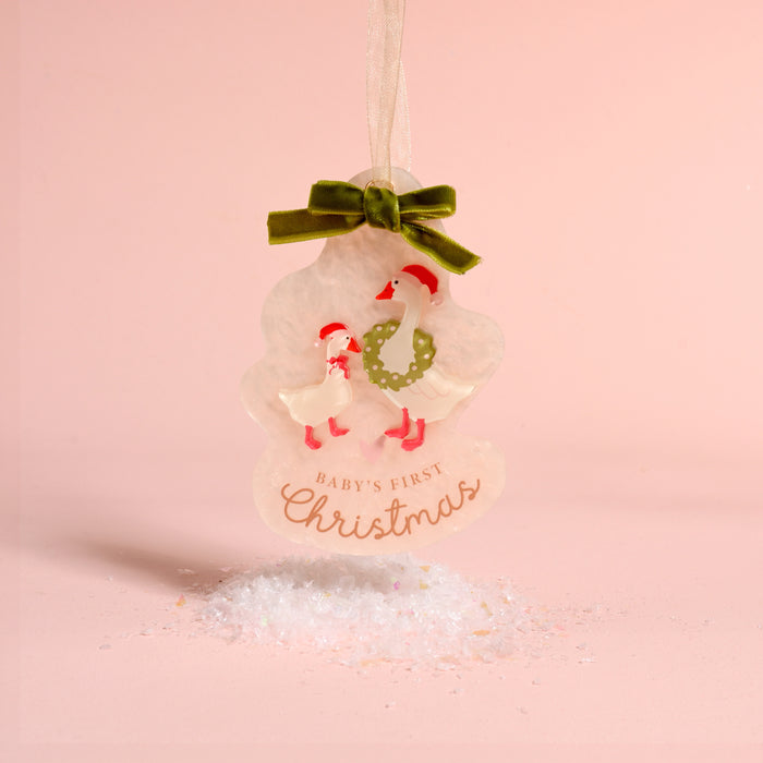 Tree-shaped Baby’s First Christmas 2026 Acrylic Ornament featuring two geese in Santa hats, a green ribbon bow, and the text Baby’s First Christmas.
