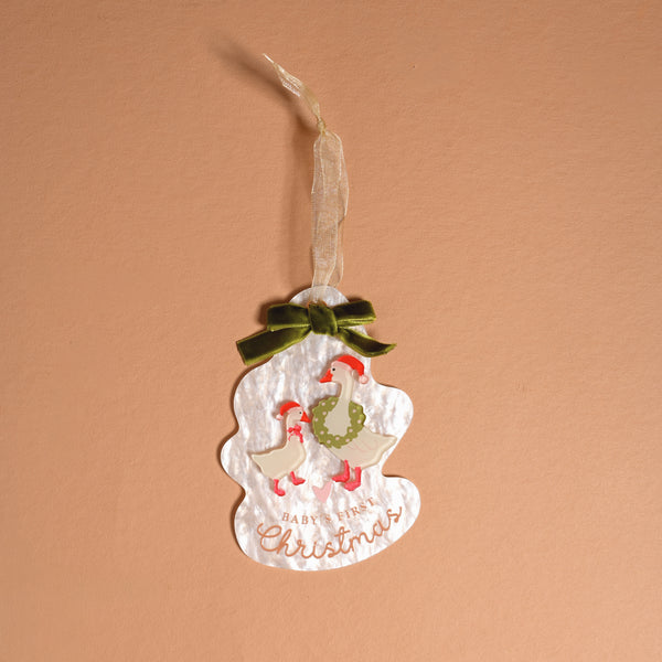 Baby’s First Christmas 2026 Acrylic Ornament featuring two illustrated geese, a green bow, and the text Baby’s First Christmas on an irregularly shaped ornament.