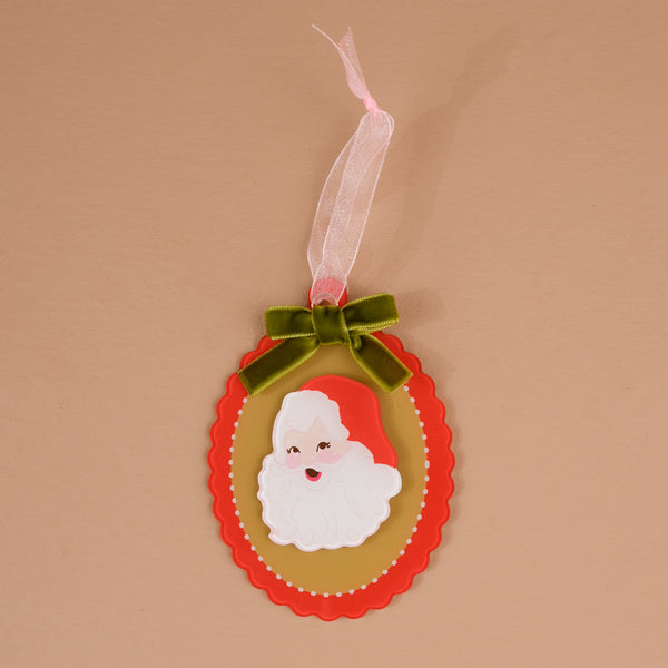 Retro Santa Acrylic Ornament featuring an oval-shaped design with a retro Santa Claus illustration, trimmed with a green ribbon bow and a hanging loop for elegant holiday styling.