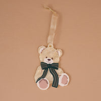 Teddy Bear Theo Acrylic Ornament shaped like a teddy bear with a dark green striped bow and a ribbon hanger, perfect for holiday styling.