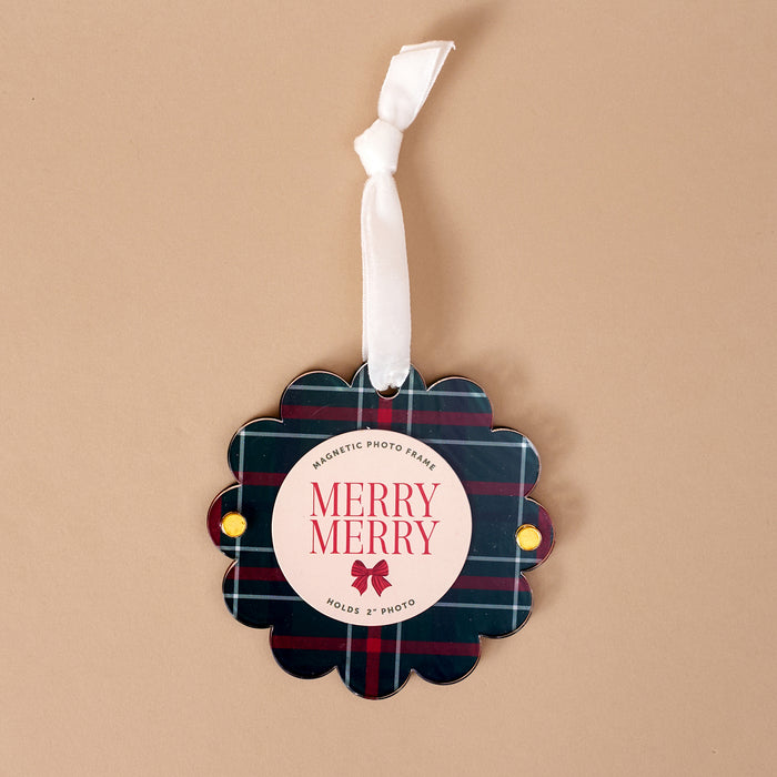 Evergreen Plaid Scalloped Round Picture Frame Ornament featuring a dark green and red plaid pattern, hanging from a white ribbon, with Merry Merry text and a red bow icon.
