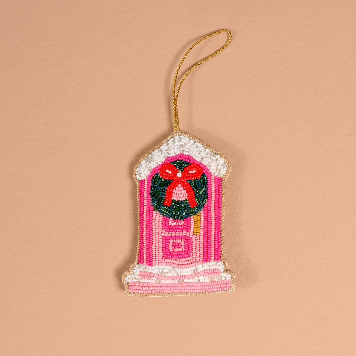 Darling Doorstep Handcrafted Beaded Ornament in the shape of a pink front door with a green wreath and a red bow.