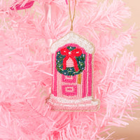 Darling Doorstep Handcrafted Beaded Ornament shaped like a pink door with a green wreath and a red bow, hanging on a pink artificial holiday décor tree.