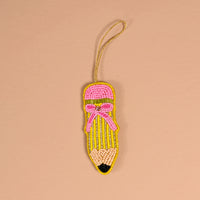 The Darling Effect Pencil Handcrafted Beaded Ornament shaped like a pencil with a pink eraser, yellow body, and black tip, featuring a decorative pink bow and a gold hanging loop.