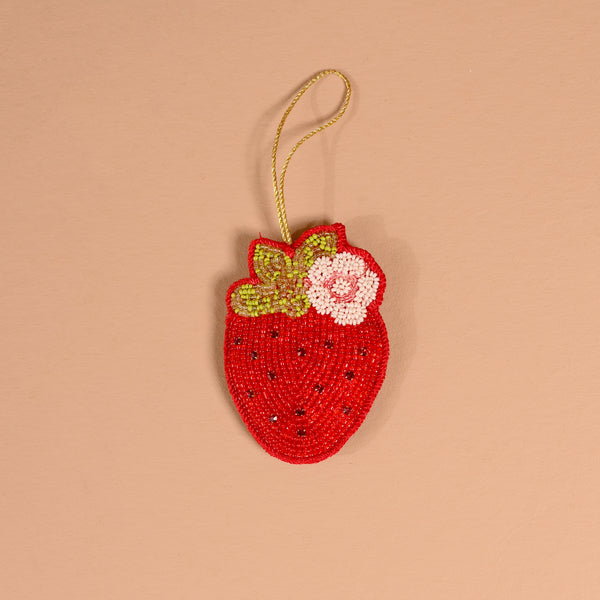 A Strawberry Handcrafted Beaded Ornament shaped like a strawberry, featuring red, green, and white beads with a gold hanging loop.