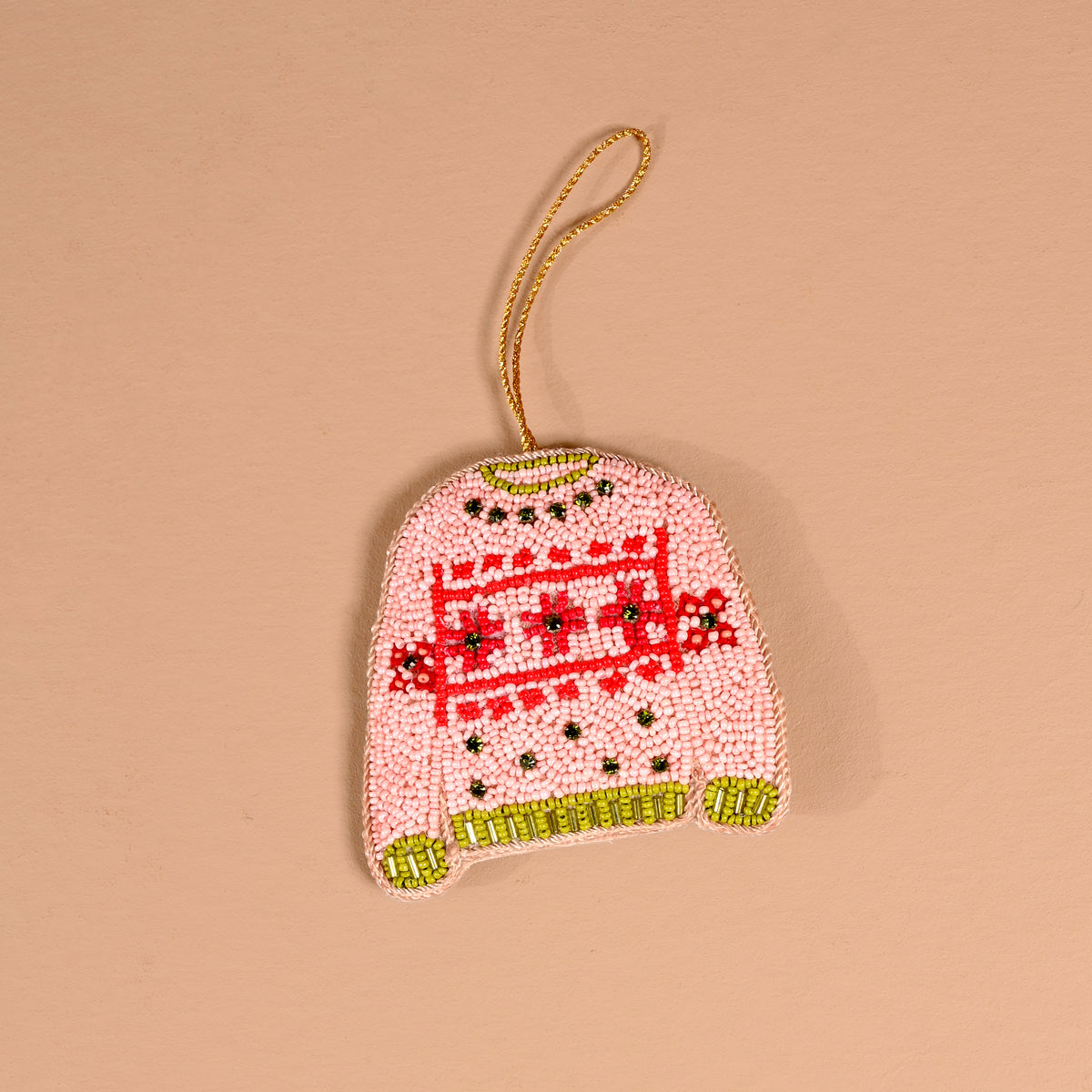 The Darling Effect Christmas Sweater Handcrafted Beaded Ornament shaped like a pink sweater with red and green patterns and a gold hanging loop.