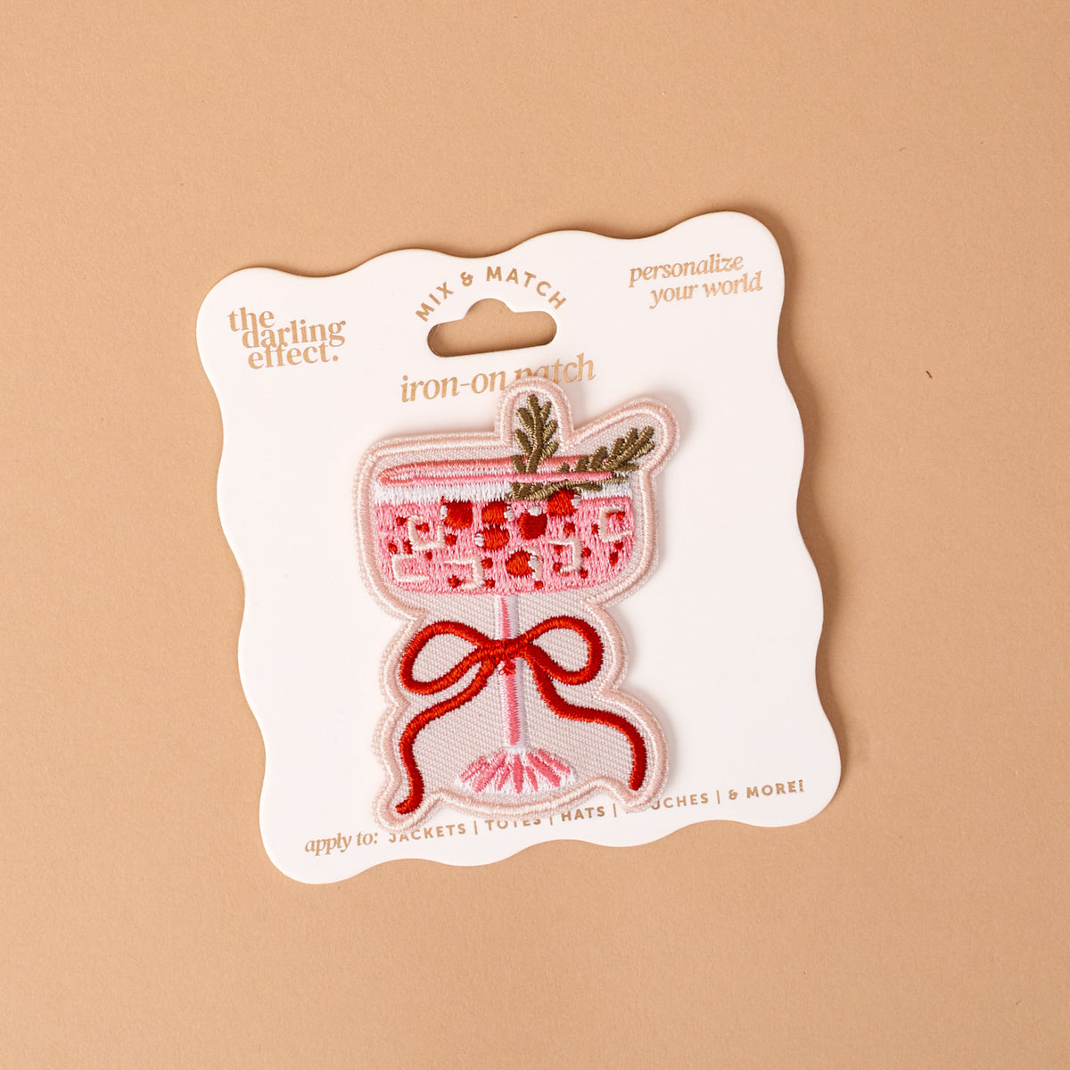 Cranberry Cosmo Mix & Match Iron-On Patch featuring a colorful embroidered pink cocktail in a stemmed glass, garnished with a sprig of rosemary and tied with a red ribbon.