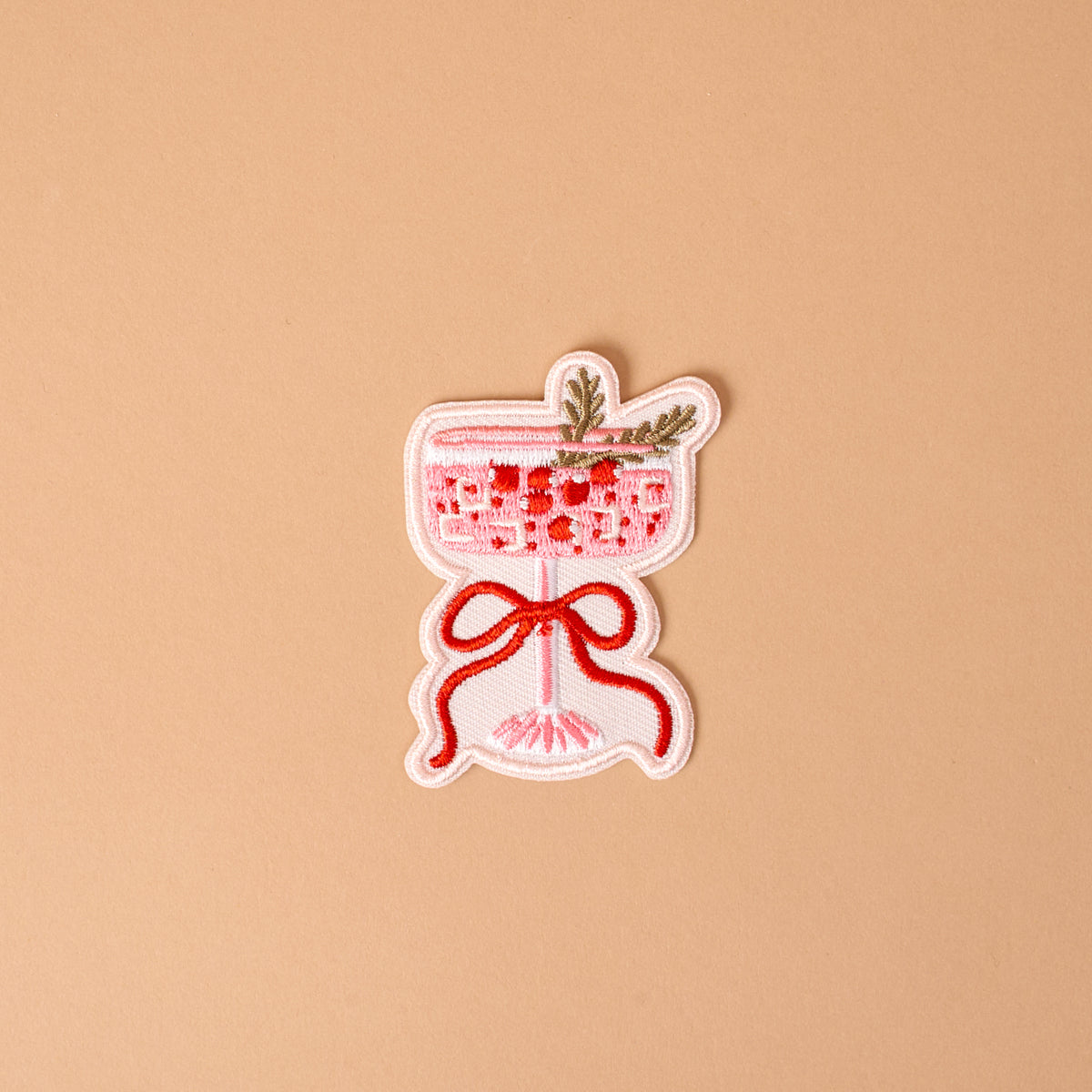 Cranberry Cosmo Mix & Match Iron-On Patch featuring an embroidered pink cocktail in a stemmed glass, garnished with a sprig and tied with a red ribbon to customize jackets.