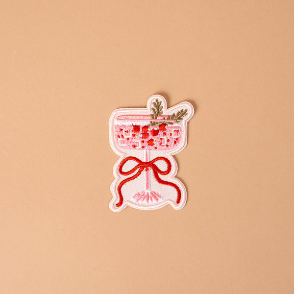 Cranberry Cosmo Mix & Match Iron-On Patch featuring an embroidered pink cocktail in a stemmed glass, garnished with a sprig and tied with a red ribbon to customize jackets.