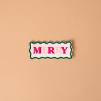 Merry Mix & Match Iron-On Patch featuring a rectangular shape with wavy green edges and the word MERRY in pink embroidered letters on a white background.