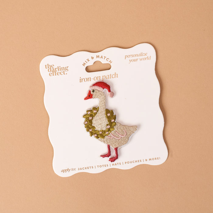 Merry Silly Goose Mix & Match Iron-On Patch by The Darling Effect, featuring an embroidered goose wearing a Santa hat and a holiday wreath on a display card.