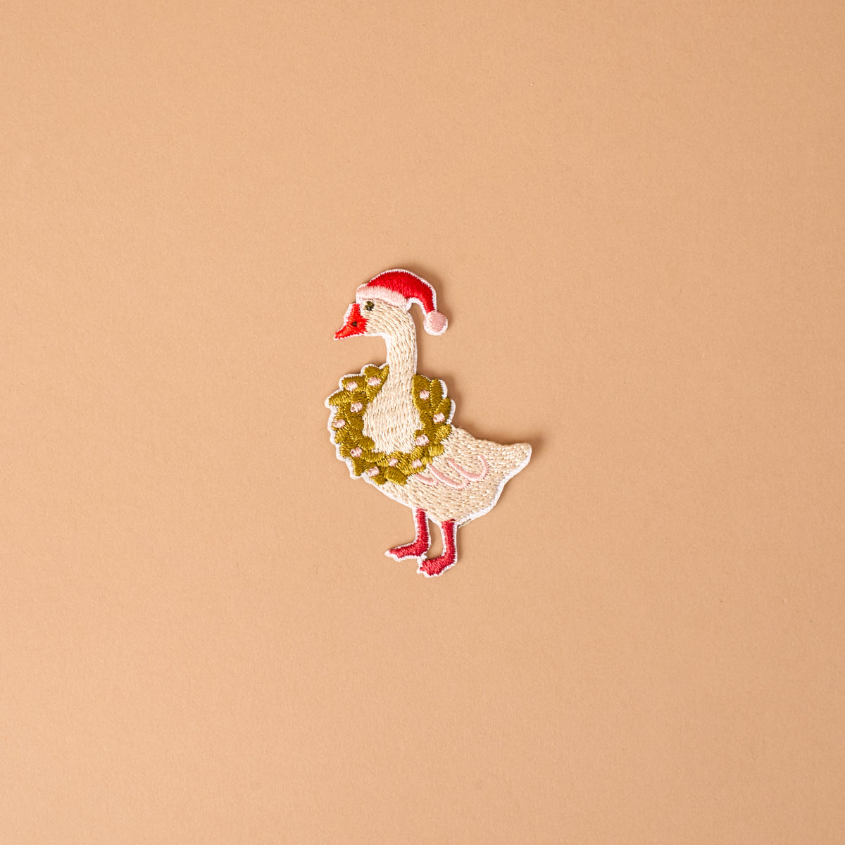 Merry Silly Goose Mix & Match Iron-On Patch featuring a goose wearing a red Santa hat and a festive wreath.