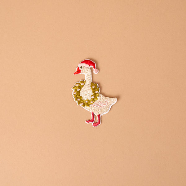Merry Silly Goose Mix & Match Iron-On Patch featuring a goose wearing a red Santa hat and a festive wreath.