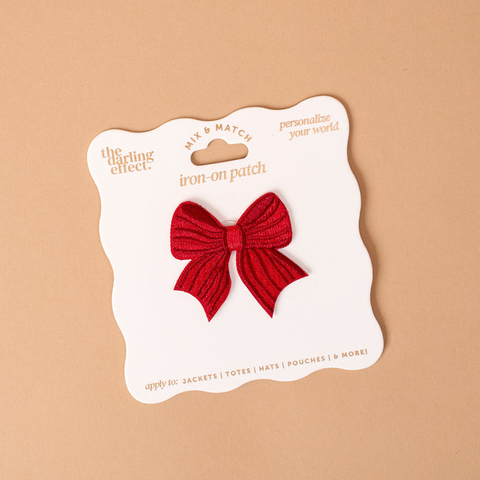 Red Bow Mix & Match Iron-On Patch featuring a red embroidered bow-shaped patch on white packaging, designed for customizing jackets.