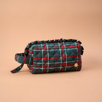 Evergreen Plaid Essentials Quilted Cosmetic Pouch in a green and red plaid pattern with a ruffled edge and a side carry strap.