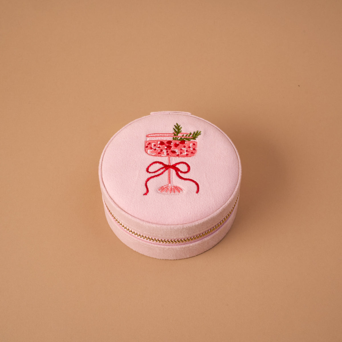 Cranberry Cosmo Round Velvet Jewelry Case in pink, featuring an embroidered cocktail glass design on the lid.