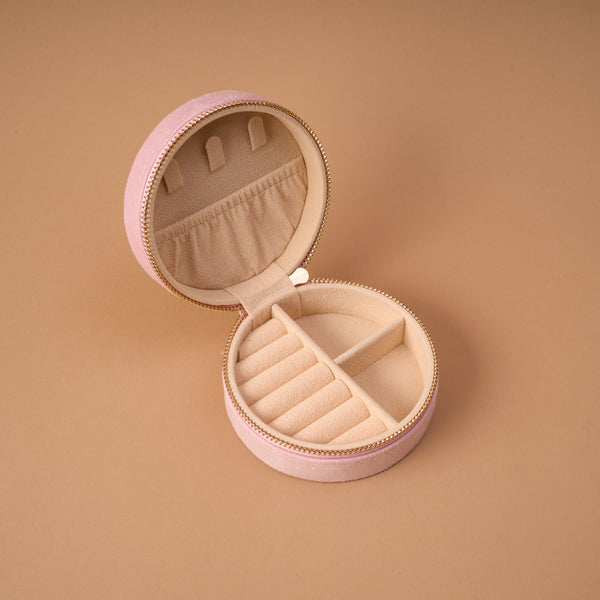Cranberry Cosmo Round Velvet Jewelry Case, a round, pink velvet travel case with an open lid featuring a pocket and ring slots.