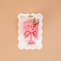 The Cranberry Cosmo Shape Up Claw Clip by The Darling Effect is a pink, cocktail-shaped hair claw clip presented on a branded card as a cute hairstyle accessory.