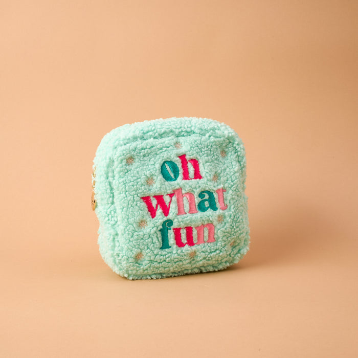 Square Oh What Fun Teddy Pouch in mint green sherpa with oh what fun embroidered in pink and dark teal letters.