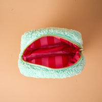 Mint green sherpa Square Oh What Fun Teddy Pouch featuring a gold zipper and a pink-and-red striped interior lining.