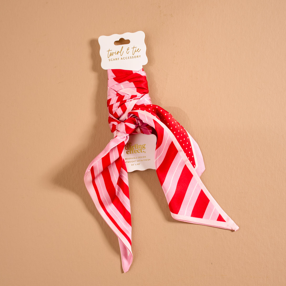 Peppermint Stripes Twirl & Tie Scarf Accessory in red and pink striped satin tied in a knot on a display card.