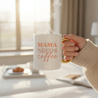 The Darling Effect's Mama Needs Coffee 11 oz Cozy Cute Ceramic Mug features "MAMA NEEDS coffee" in pastel colors with a golden handle, making it perfect for coffee and tea lovers.
